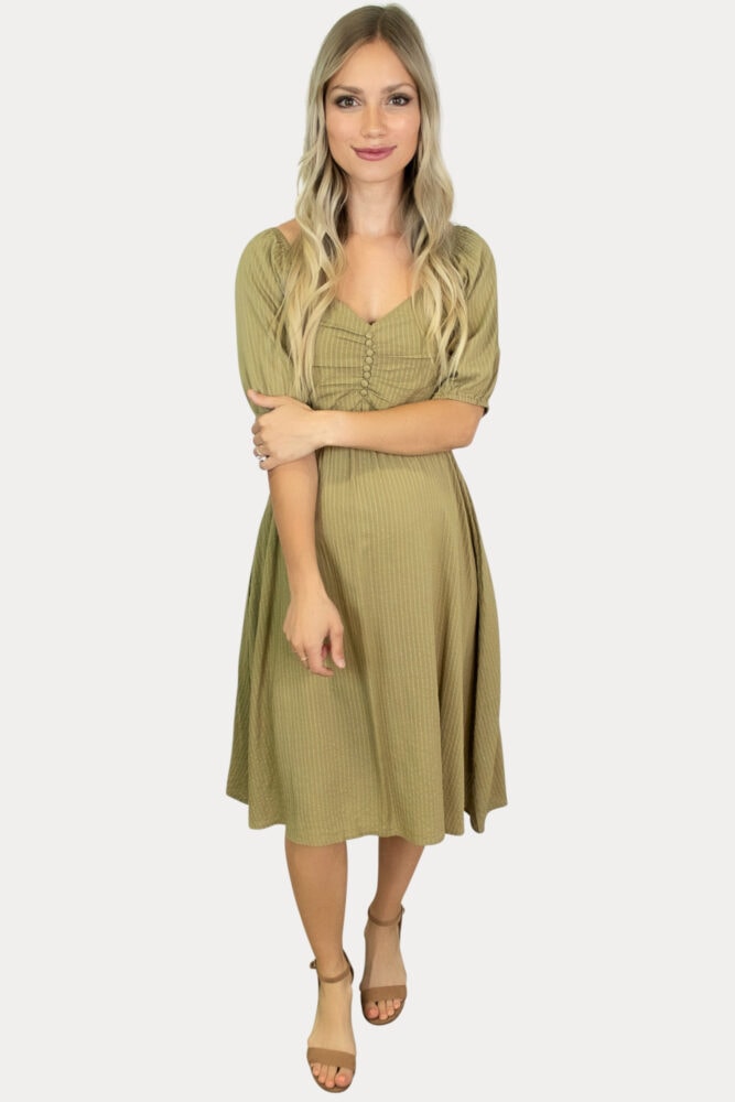 Our striped button down maternity dress in olive is sure to add a subtle elegance to your mama wardrobe!