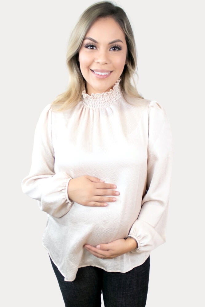 This stylish turtleneck maternity top is sure to impress in a stunning champagne color, flowy bell sleeves and ruffled neckline!